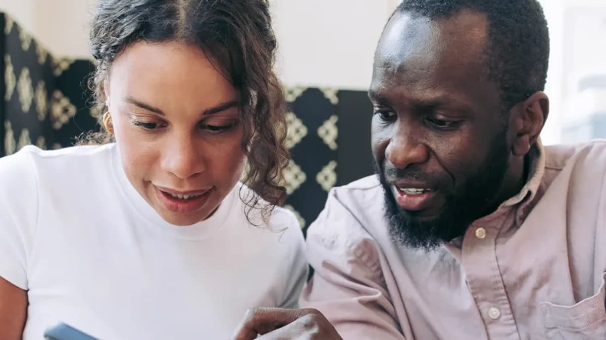 An accountant and a client reviewing the reconciled books together on a phone